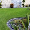 Gabion wall, purple slate and fresh garden lawn turf