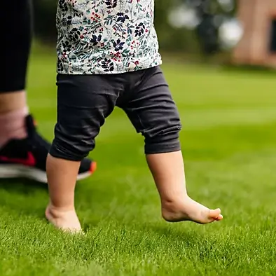 Rolawn Medallion Turf - Baby walking across fresh grass