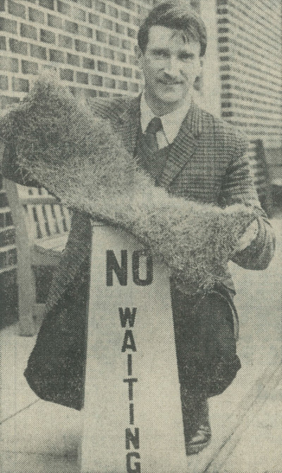 Image of Ken Dawson holding a piece of turf aloft in 1975