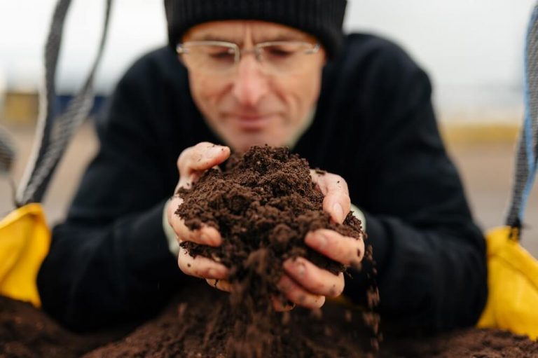 Terry Smithson, Rolawn Biodiversity Manager, with topsoil.